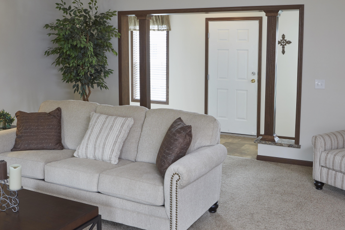 Front entrance with a white couch and a white door in Montclair model
